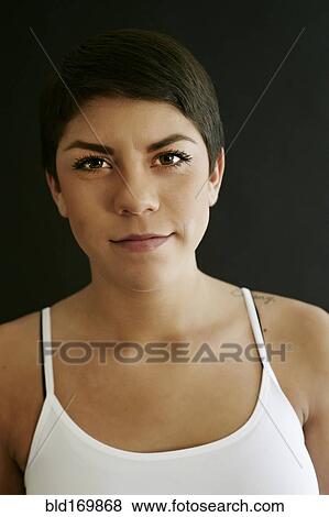 Stock Photo - Close up of Hispanic woman with serious expression. Fotosearch
