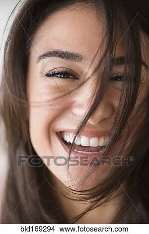 Picture - Close up of laughing woman with messy hair. Fotosearch