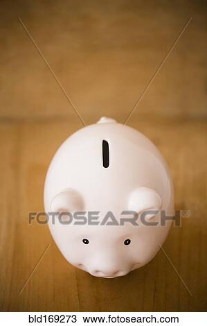 Close up of piggy bank on table View Large Photo Image Stock Image - Close up of piggy bank on table. Fotosearch
