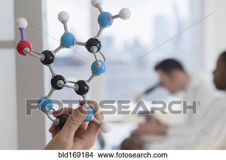 Picture - Close up of scientist holding molecular model in lab. Fotosearch