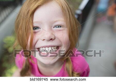 Stock Photography - Close up of smiling Caucasian girl. Fotosearch