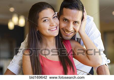 Close up of smiling Hispanic couple hugging View Large Photo Image Stock Image - Close up of smiling Hispanic couple hugging. Fotosearch