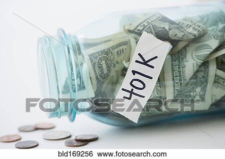 Stock Photograph - Close up of spilling 401K savings jar. Fotosearch