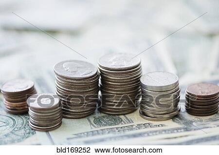 Stock Image - Close up of stacks of coins and money. Fotosearch