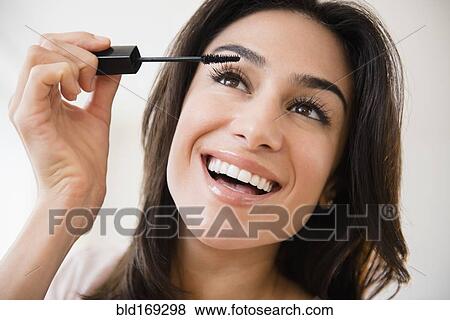Stock Photo - Close up of woman applying makeup. Fotosearch