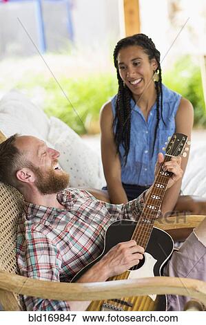 Couple playing music in backyard View Large Photo Image Stock Photo - Couple playing music in backyard. Fotosearch