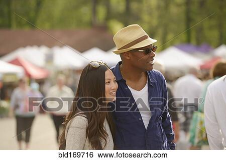 Stock Photograph - Couple shopping at farmers market. Fotosearch