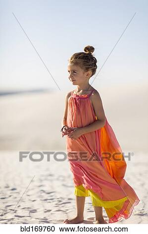 Girl standing on desert sand dune View Large Photo Image Stock Image - Girl standing on desert sand dune. Fotosearch