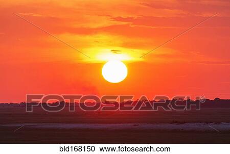 Stock Image - Glowing sunset over remote landscape. Fotosearch