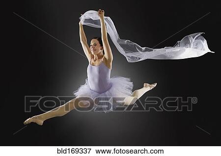 Hispanic ballet dancer leaping in mid-air View Large Photo Image Stock Photo - Hispanic ballet dancer leaping in mid-air. Fotosearch