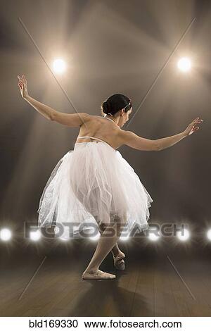 Hispanic ballet dancer performing on stage View Large Photo Image Stock Image - Hispanic ballet dancer performing on stage. Fotosearch