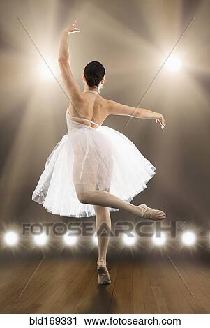 Stock Image - Hispanic ballet dancer performing on stage. Fotosearch