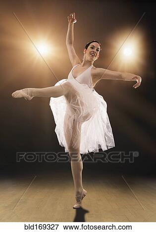 Stock Photo - Hispanic ballet dancer performing on stage. Fotosearch