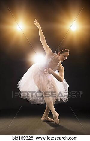 Stock Photo - Hispanic ballet dancer performing on stage. Fotosearch