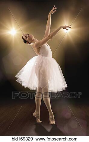 Stock Photo - Hispanic ballet dancer performing on stage. Fotosearch