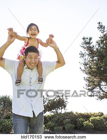 Hispanic father carrying daughter on shoulders View Large Photo Image Stock Image - Hispanic father carrying daughter on shoulders. Fotosearch