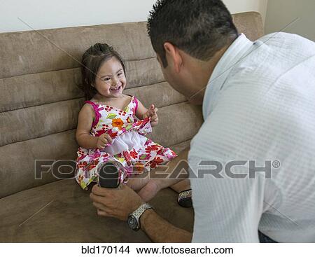 Hispanic father helping daughter put on shoes View Large Photo Image Picture - Hispanic father helping daughter put on shoes. Fotosearch