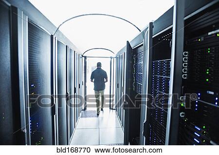 Stock Image - Hispanic technician leaving server room. Fotosearch