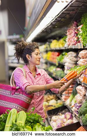 Hispanic woman shopping at grocery store View Large Photo Image Picture - Hispanic woman shopping at grocery store. Fotosearch