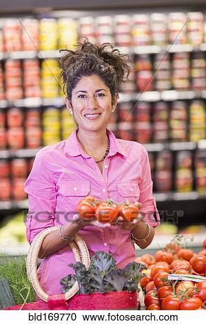 Hispanic woman shopping at grocery store View Large Photo Image Stock Image - Hispanic woman shopping at grocery store. Fotosearch