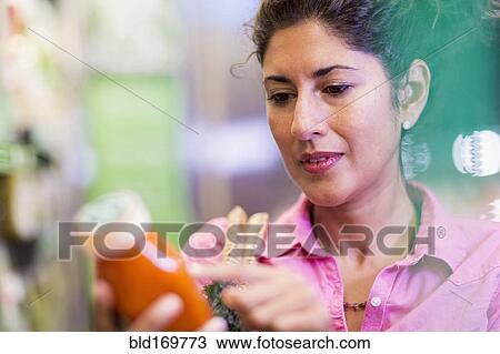 Hispanic woman shopping at grocery store View Large Photo Image Stock Image - Hispanic woman shopping at grocery store. Fotosearch