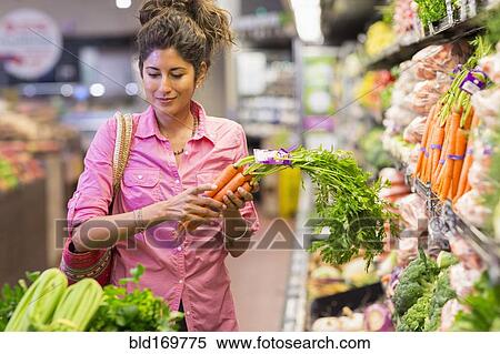 Hispanic woman shopping at grocery store View Large Photo Image Stock Photography - Hispanic woman shopping at grocery store. Fotosearch