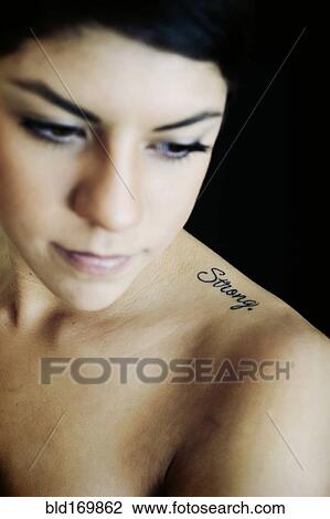Hispanic woman with strong tattoo on shoulder View Large Photo Image Stock Image - Hispanic woman with strong tattoo on shoulder. Fotosearch