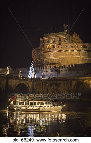 Stock Photo - Illuminated boat floating on river, Rome, Italy. Fotosearch