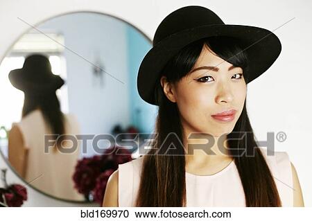 Japanese woman standing at mirror View Large Photo Image Stock Image - Japanese woman standing at mirror. Fotosearch