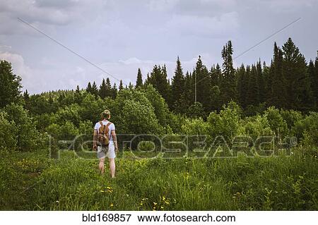Stock Photo - Man standing in rural field. Fotosearch