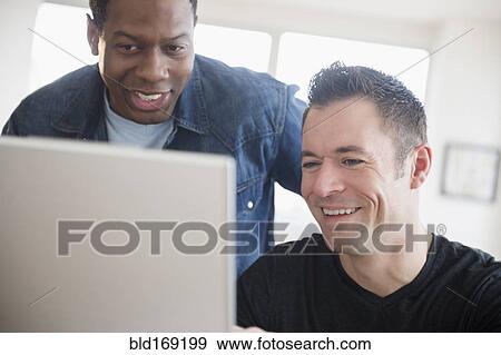 Stock Photo - Men using computer in office. Fotosearch