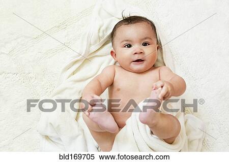 Mixed race baby playing with feet View Large Photo Image Stock Photography - Mixed race baby playing with feet. Fotosearch