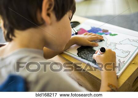 Mixed race boy coloring map with crayon View Large Photo Image Stock Photo - Mixed race boy coloring map with crayon. Fotosearch