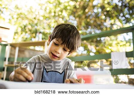 Mixed race boy coloring on porch View Large Photo Image Stock Photo - Mixed race boy coloring on porch. Fotosearch