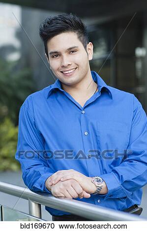 Mixed race businessman leaning on banister outdoors View Large Photo Image Stock Image - Mixed race businessman leaning on banister outdoors. Fotosearch