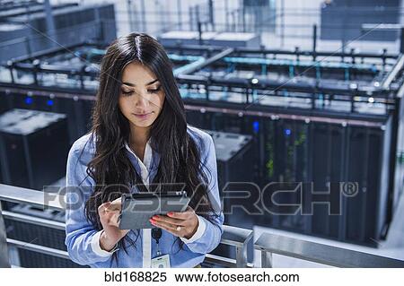 Mixed race businesswoman using digital tablet on balcony over server room View Large Photo Image Stock Photography - Mixed race businesswoman using digital tablet on balcony over server room. Fotosearch