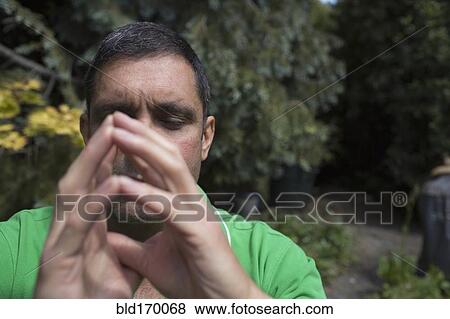 Mixed race man concentrating with hands clasped View Large Photo Image Stock Photo - Mixed race man concentrating with hands clasped. Fotosearch