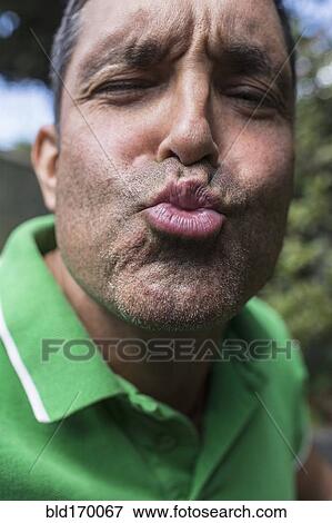 Stock Photo - Mixed race man puckering. Fotosearch
