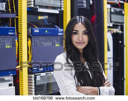 Mixed race technician smiling in server room View Large Photo Image Stock Photograph - Mixed race technician smiling in server room. Fotosearch