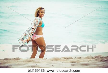 Mixed race teenager wearing bikini on beach View Large Photo Image Stock Photograph - Mixed race teenager wearing bikini on beach. Fotosearch