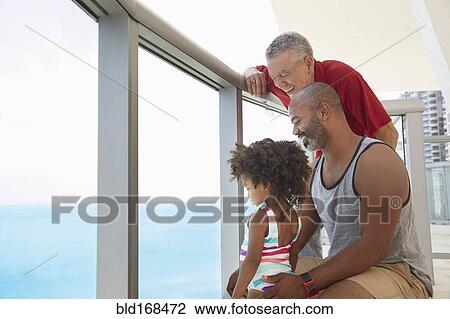 Multi-generation family overlooking ocean from balcony View Large Photo Image Stock Image - Multi-generation family overlooking ocean from balcony. Fotosearch