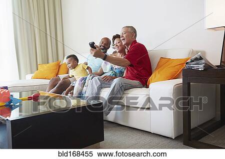 Multi-generation family taking selfie in living room View Large Photo Image Stock Photography - Multi-generation family taking selfie in living room. Fotosearch