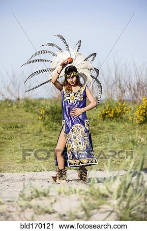 Native American woman in traditional headdress performing ceremony View Large Photo Image Stock Image - Native American woman in traditional headdress performing ceremony. Fotosearch