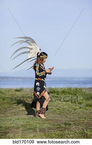 Native American woman in traditional headdress performing ceremony View Large Photo Image Stock Photo - Native American woman in traditional headdress performing ceremony. Fotosearch