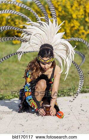 Native American woman in traditional headdress performing ceremony View Large Photo Image Stock Photo - Native American woman in traditional headdress performing ceremony. Fotosearch