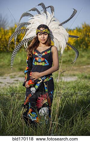 Stock Photo - Native American woman in traditional headdress performing ceremony. Fotosearch
