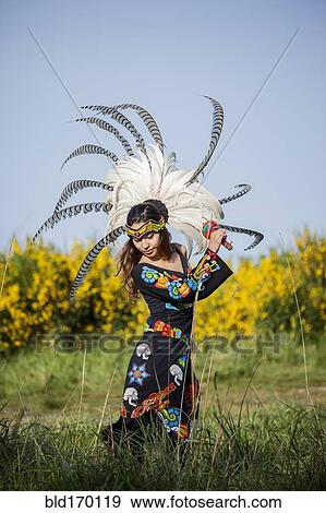Stock Photo - Native American woman in traditional headdress performing ceremony. Fotosearch