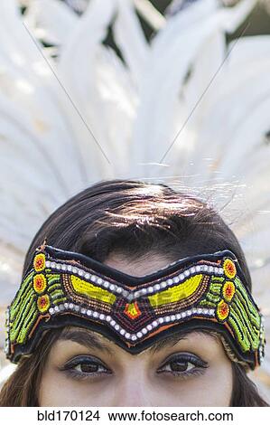 Picture - Native American woman wearing traditional headdress. Fotosearch