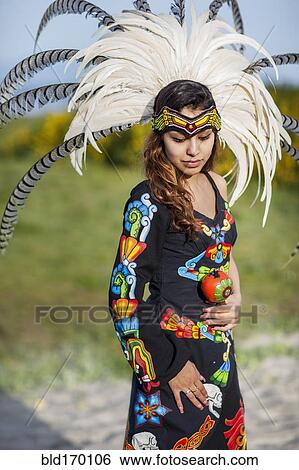 Stock Photograph - Native American woman wearing traditional headdress. Fotosearch