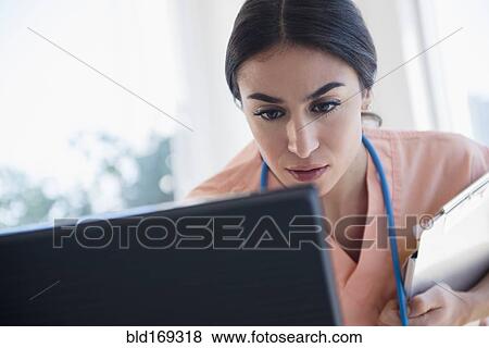 Stock Photo - Nurse using computer in hospital. Fotosearch